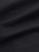 Pantalón de punto negro con pierna ancha, talle alto y monograma de Calvin Klein bordado.
