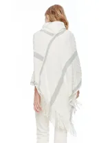 Poncho tejido Barrington color blanco con diseño de rombos en relieve y franjas diagonales grises. Posee cuello alto de tejido afelpado (velour) blanco y terminación con flecos en el ruedo.