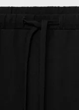 Pantalón largo negro de viscosa, poliamida, poliéster y elastano, con cintura elástica ajustable con lazo, tiro medio y diseño recto.