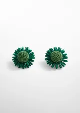 Par de aros con forma de flor verde, con centro de cuentas y pétalos de rafia. Cierre a presión.