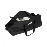 Bolso deportivo Adidas Tiro L Duffle, color negro con logo blanco, con doble asa de mano y correa ajustable para el hombro. Incluye compartimento principal con cierre, bolsillo lateral con cierre y bolsillo interior. Ideal para transportar ropa y calzado deportivo.