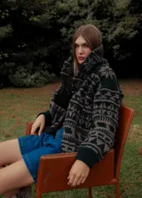 Saco de lana con capucha, base topo y detalles en verde.