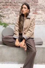 Cazadora color beige con apliques de pedrería y detalles en color marrón.