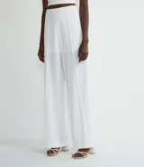 Pantalón blanco de crepe, corte palazzo, con cintura alta y pinzas frontales.