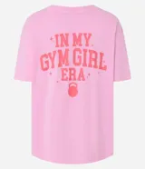 Remera deportiva oversized de malla de algodón color rosa, con cuello redondo y mangas cortas. Estampa frontal con la frase "Gym Girl" y estampa grande en la espalda.