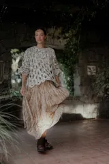 Pollera larga color beige con textura arrugada y abertura frontal.