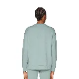 Buzo Puma de corte relajado color verde agua con logo blanco estampado en el pecho.