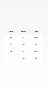 Top halter de seda color marrón oscuro con estampado de lunares blancos. El ruedo tiene un corte asimétrico y está terminado con un borde de encaje negro.