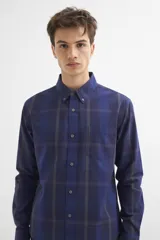 Camisa azul a cuadros grises de manga larga con cuello abotonado y bolsillo en el pecho.
