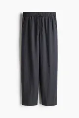 Pantalón tobillero de corte holgado en tejido liviano de mezcla de lino. Modelo de tiro alto con elástico revestido y cordón para ajustar fino en la cintura, bolsillos al bies y piernas ajustadas.