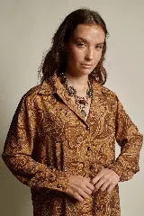 Camisa estampada color marrón con diseño cachemir, corte holgado, cuello solapa y abotonada.