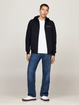 Buzo azul marino con capucha, cierre de cremallera frontal, bolsillos tipo canguro y logo de Tommy Hilfiger bordado en el pecho.