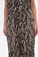 Pantalón de lyocell con estampado abstracto en tonos beige y negro, corte palazzo y cintura elastizada.