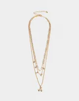 Collar corto dorado de múltiples cadenas con dijes de strass y cerezas.