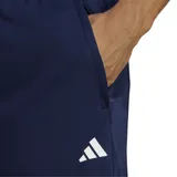 Shorts deportivos Adidas Train Essentials, color azul marino, con logo blanco estampado en la pierna izquierda, cintura elástica con cordón ajustable y aberturas laterales para mayor libertad de movimiento. Confeccionados en tejido de punto doble suave y tecnología AEROREADY para mantener la piel seca.