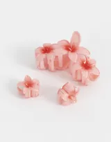 Set de tres broches para el pelo con forma de flores hawaianas color rosa.