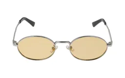 Lentes de sol con marco plateado y lentes amarillas de forma ovalada.