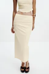 Falda midi color crema, de tiro alto con cintura elástica y detalle de pliegues laterales.