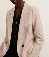 Broche plateado tipo alfiler de gancho con cadenas colgantes, dijes de corazón y esfera.