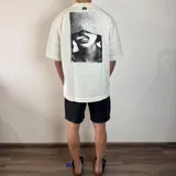 Remera negra de corte oversize y mangas cortas, con estampa en la espalda de una fotografía en blanco y negro de una persona fumando.