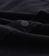 Camisa de manga larga color marrón, confeccionada en sarga de algodón, con cuello inglés, botones frontales y dos bolsillos de parche con solapa y botón en el pecho.