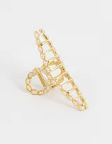 Broche dorado para el pelo con forma de pinza y apliques de perlas sintéticas.