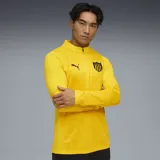 Camiseta de entrenamiento Puma color amarillo con cierre corto, escudo del Club Atlético Peñarol y logo de Puma estampados en negro.