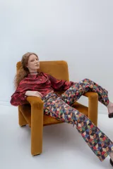 Camisa crop azul con estampado de motivos abstractos en blanco y rosa, cuello clásico y lazo en el escote.