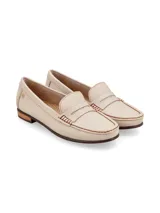 Mocasín de cuero color crema, con suela marrón y detalle de costuras en contraste.