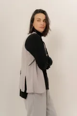 Chaleco sastrero gris claro con botones, de corte recto y sin mangas.