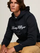 Buzo negro con capucha de Tommy Hilfiger. Tiene el logo de la marca bordado en blanco en el pecho y el logo de la bandera en el puño.
