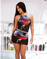 Conjunto de top musculosa y minifalda ajustada con estampado de rosa roja sobre fondo negro y azul.