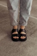 Sandalias color beige con tiras de cuero y ajuste con velcro, con base chunky negra.