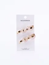Set de dos broches para el pelo con forma de cadena color crema y detalles dorados.