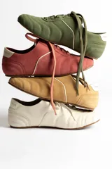 Zapatillas acordonadas color beige con detalles en blanco.