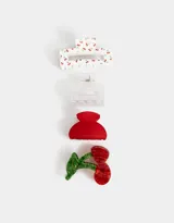 Set de cuatro broches para el pelo con forma de pinza. Incluye un broche blanco con estampado de cerezas, uno transparente, uno rojo y uno con forma de cereza.