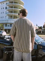 Polo de punto con fit relajado y diseño estructurado. Tejido estilo urbano con cuello tipo camisa, cierre con botones y mangas cortas.