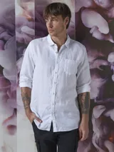 Camisa azul de lino con botones blancos, manga larga y bolsillo en el pecho.