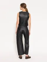 Pantalón de cuero vacuno negro con laterales en gabardina al tono. El acceso es mediante cierre metálico y botón jeanero. Incluye bolsillos estilo jeanero al frente y bolsillos plaque en la parte trasera.