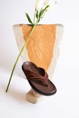 Sandalias marrones con tira ancha de cuero sintético trenzado.