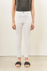 Pantalón jean blanco de tiro medio y calce slim, con largo al tobillo.