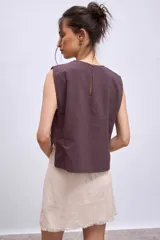 Blusa blanca sin mangas con cuello redondo y corte crop.