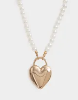 Collar corto de perlas blancas con dije dorado en forma de corazón con forma de candado.