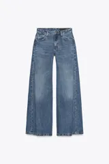 Pantalón de jean de tiro bajo, color azul, con corte flare, cinco bolsillos, pliegues laterales y efecto lavado.