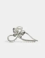 Broche dorado para el pelo con forma de moño y mariposa.