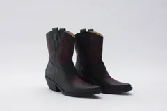 Bota texana de cuero negro con bordados en el lateral y taco bajo.