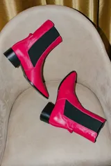Botas de cuero rojas con elástico negro en los laterales, punta cuadrada y taco bajo.