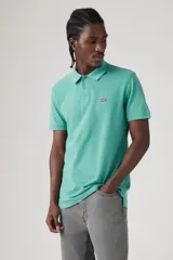 Chomba manga corta color celeste con cuello clásico y logo de la marca bordado en el pecho.