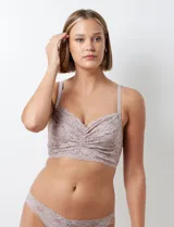 Conjunto de lencería color lila, compuesto por un bralette de encaje floral sin aro ni relleno, con breteles regulables y cierre trasero, y una bombacha tipo colaless de encaje floral con elástico fino.