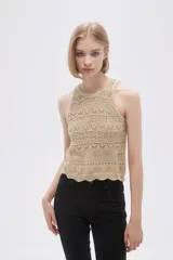 Musculosa de tejido crochet color beige con cuello redondo y sisas con terminación acanalada.